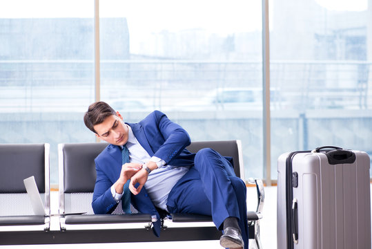 Businessman waiting at the airport for his plane in business cla