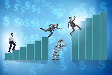 Business people jumping over bar charts
