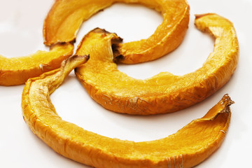 Pieces of sweet baked pumpkin close up. Selective focus. Delicious and healthy food. Sweet dessert from vegetables.