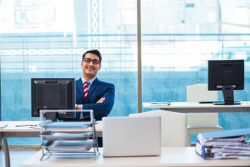 Young handsome businessman employee working in office at desk