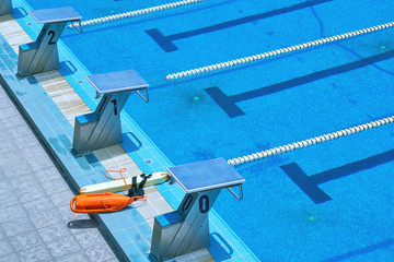 Municipal swimming pool. Texture of blue water in the pool. Bright abstract background ideal for...