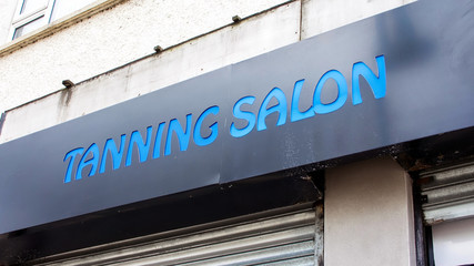 Tanning Salon shopfront sign.