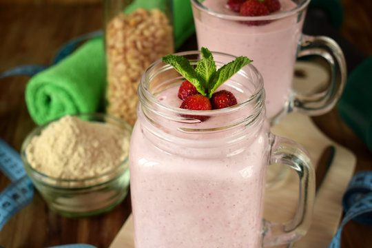 Protein cocktail with strawberries and mint in a glass jar