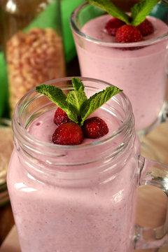 Protein cocktail with strawberries and mint in a glass jar
