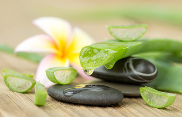 Aloe vera and frangipani flower on wooden