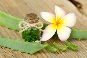 Aloe vera and frangipani flower on wooden
