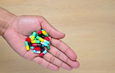 doctor hand holding a lot of medicine pills and copy space