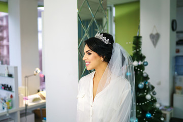 Pretty bride on the makeup before wedding ceremony