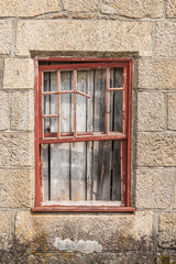 Fototapeta na wymiar A closed old window with dirty glass.