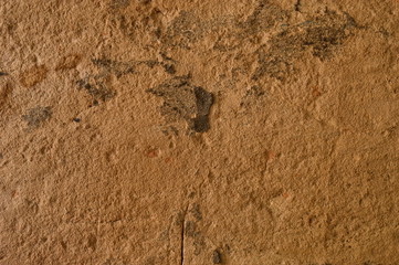 Plastered wall with sand texture. Lighting on the left