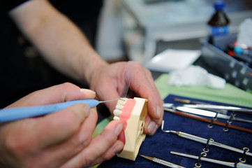 Laboratory dentist technician working on prostetic tooth close