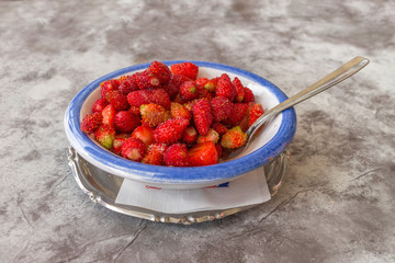 Strawberry with sugar powder in ceramic bowl