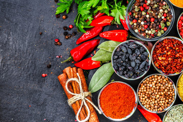 Big set of Indian spices and herbs . On the black chalkboard.