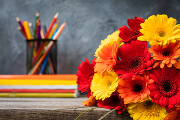 1 September concept postcard, teachers' day, back to school or college, supplies, a bunch of gerbera