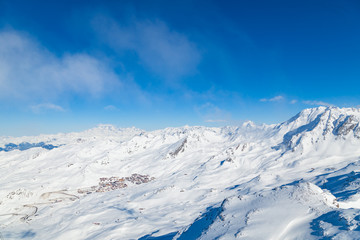 Fototapeta na wymiar Winter Alps landscape, mountains with clouds, from ski resort Val Thorens. 3 valleys (Les Trois Vallees), France