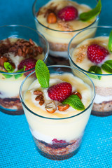 Dessert with berries, jelly, cream, nuts and mint leaf 