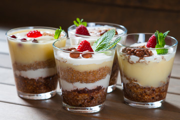 Dessert with berries, jelly, cream, nuts and mint leaf 
