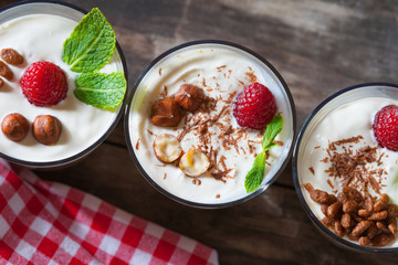 Dessert with berries, jelly, cream, nuts and mint leaf 