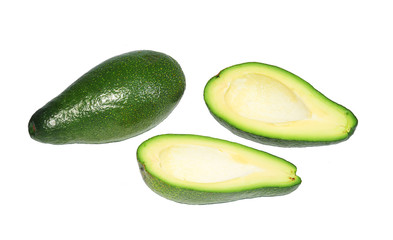 Two avocado, the whole and cut in half without bone on white background, isolated