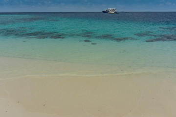 Fototapeta na wymiar Tropical white sand beach and turquoise water in Indian ocean