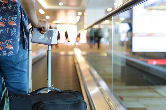 traveller with baggage take passport to check in in air port