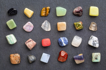colorful gemstones on slate stone
