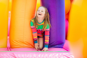 Fototapeta premium Child jumping on playground trampoline. Kids jump.