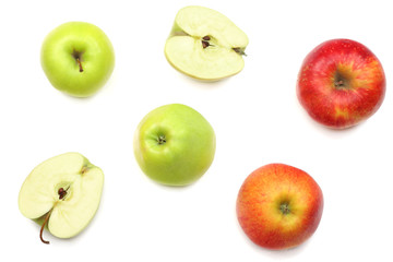 green and red apples with slices isolated on white background. top view
