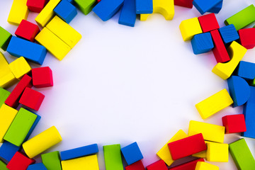 Colorful wooden building toy blocks isolated on a white background