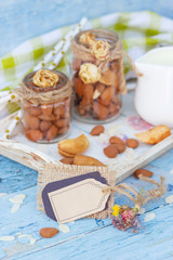 Almonds and jar with milk on the wooden tray