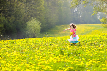Kids play. Child in dandelion field. Summer flower