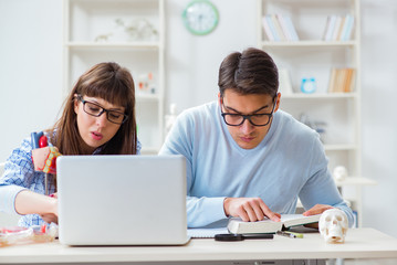 Two medical students studying in classroom