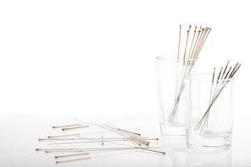 Silver needles for traditional Chinese acupuncture medicine. White background.