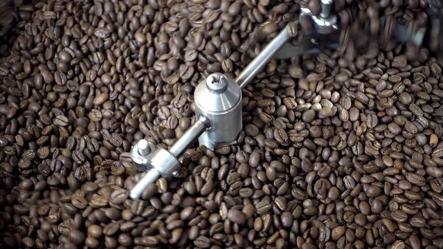 4K view of roasting of fresh coffee beans. Close-up of coffee roasters machine.                              