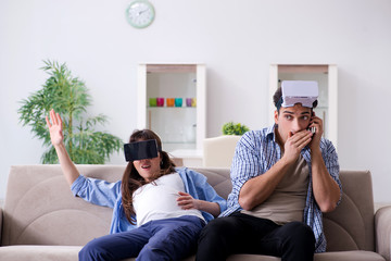 Young couple trying virtual reality glasses goggles