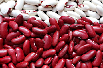 Raw white and red beans. Spilled beans. Background