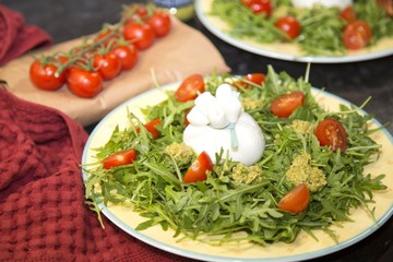Italian burrata with cherry tomatoes and pesto sauce