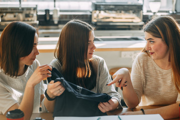 Friends discussing new purchase of young woman