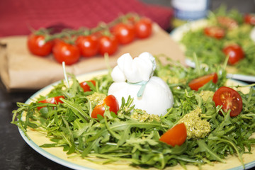 Italian burrata and mozzarella with cherry tomatoes and pesto sauce