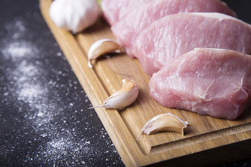 Raw slice pork on wooden board