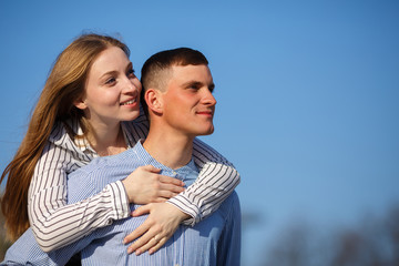 Couple hugging over sky background, copy space