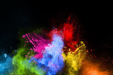 Explosion of colored powder on black background