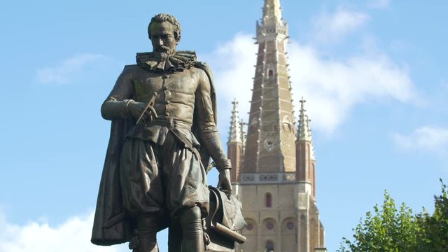 Simon Stevin statue with the Church of Our Lady