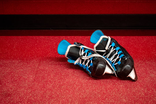 Kids Hockey Skates, Lying In Locker Room Floor With Copy Space 