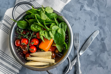 Collect fruits and vegetables in a basket on a wooden table metal colander.
