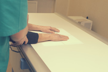 The radiologist takes X-rays of the patient on a special table.