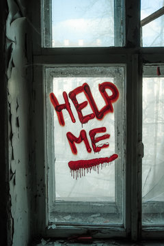 Words Help Me written on old window by blood or red paint. Depression and despair concept