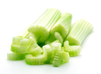 heap of sliced green celery stiks isolated on white background