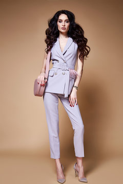 Sexy beautiful woman business lady pretty face makeup dark long hair wear dress code suit jacket trousers fashion for office style collection female boss manager accessory bag clothes catalog elegant.
