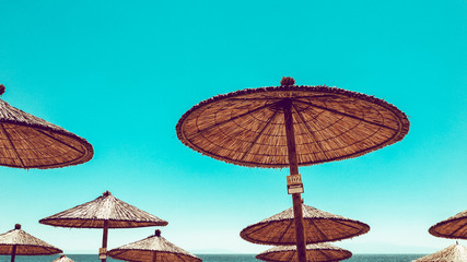 The beach umbrellas against the blue sky, sun parasols, thatched parasols, Kassandra, Greece.